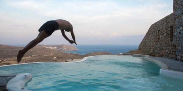 a man jumping into a pool