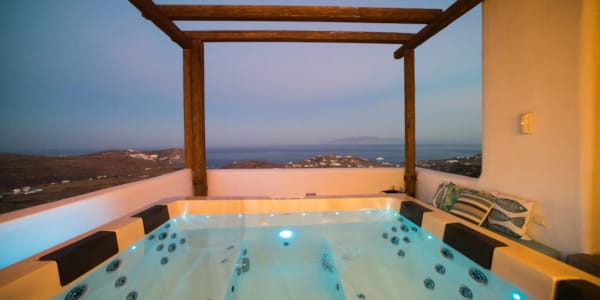 a pool with a view of the ocean and a city