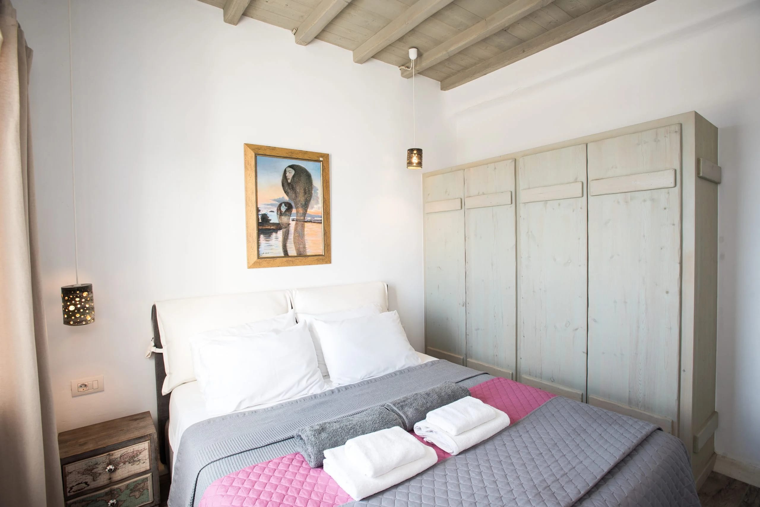 a bed with a picture on the wall