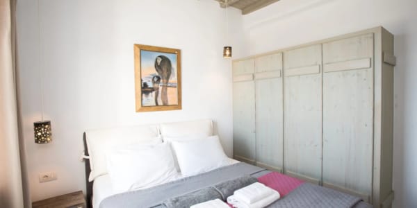 a bed with a picture on the wall