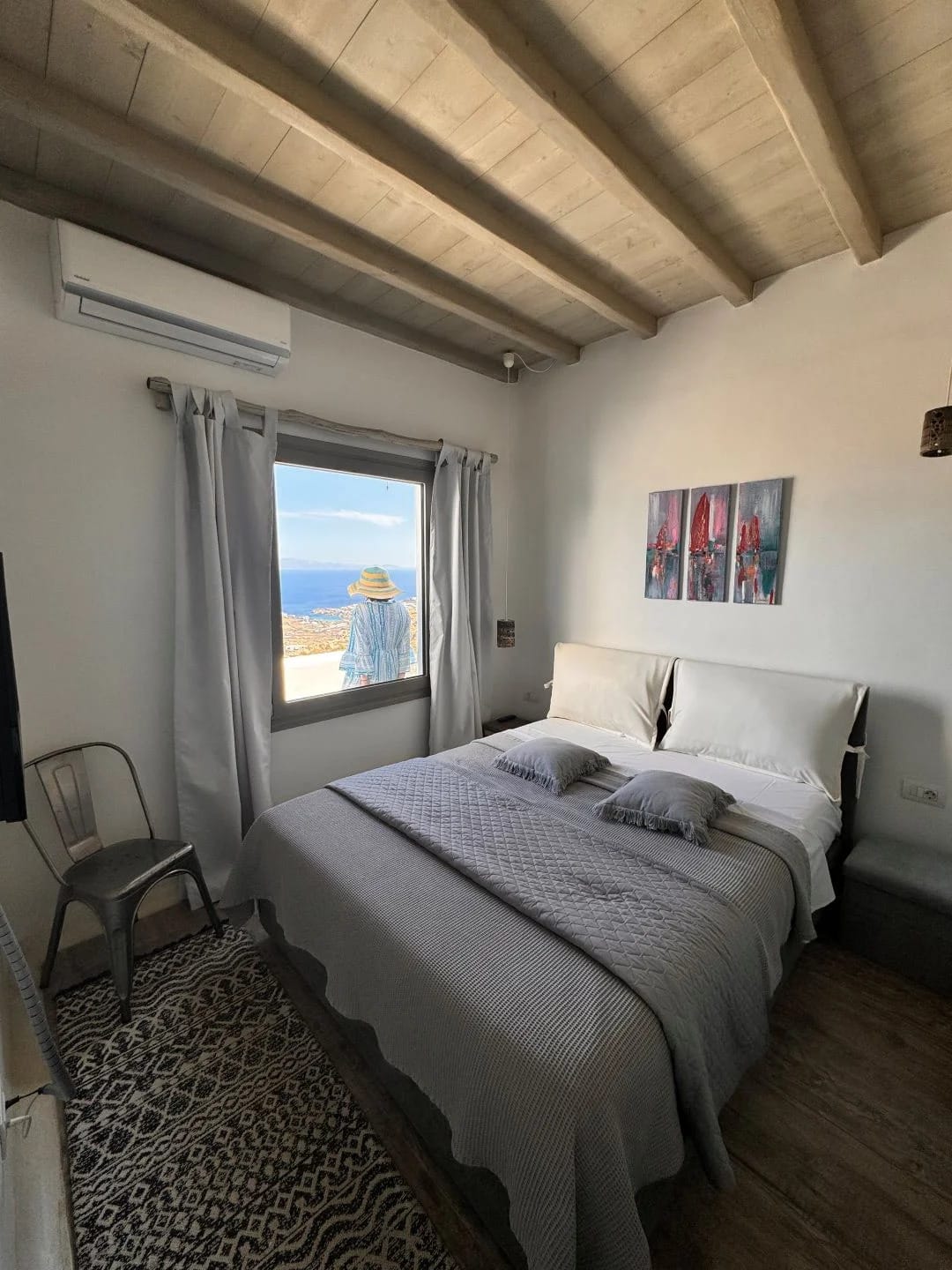 a bedroom with a bed and a chair