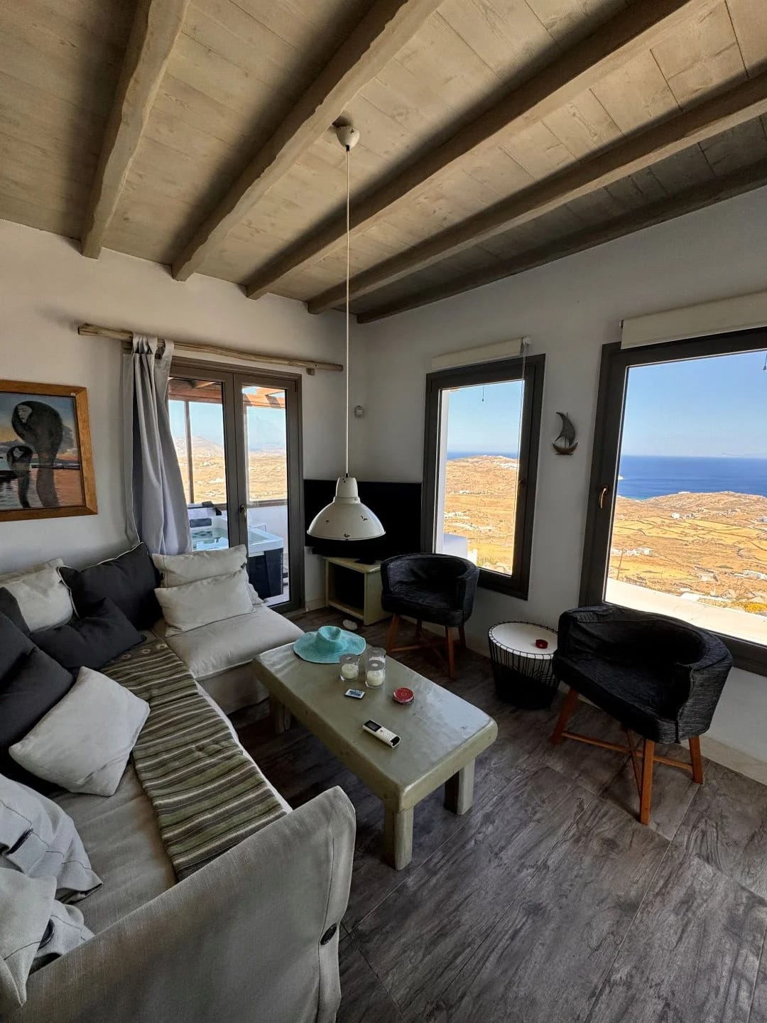 a living room with a view of the ocean