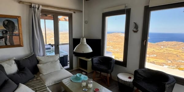 a living room with a view of the ocean
