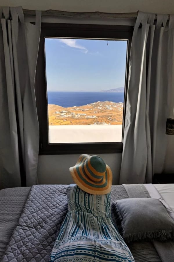 a person in a mask looking out a window