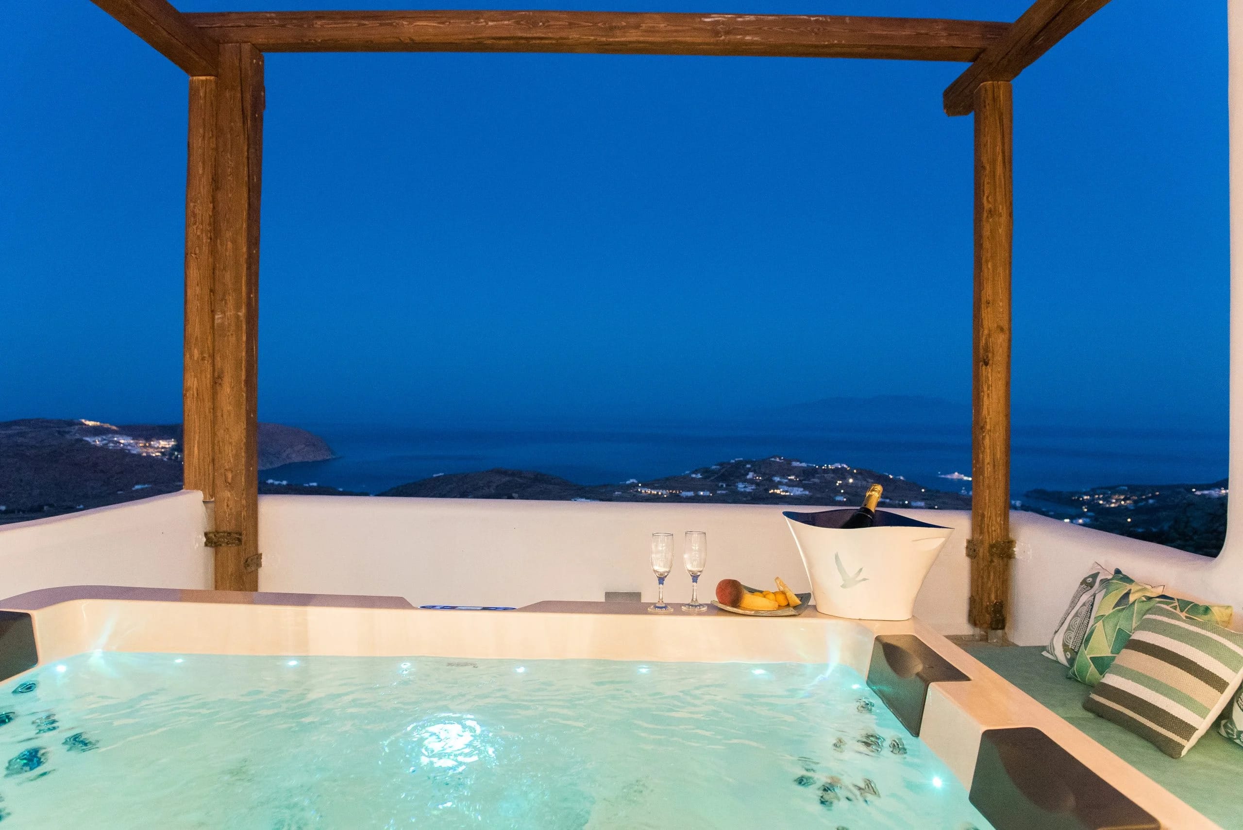a pool with a view of the ocean and mountains