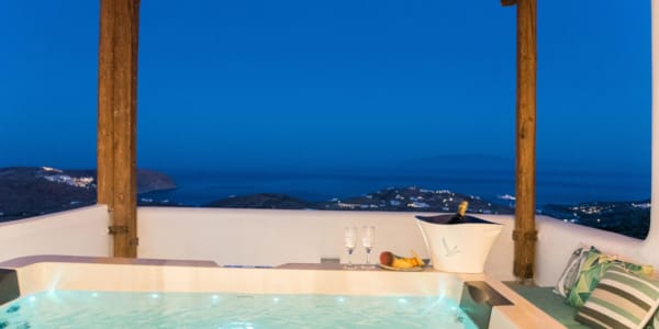 a pool with a view of the ocean and mountains