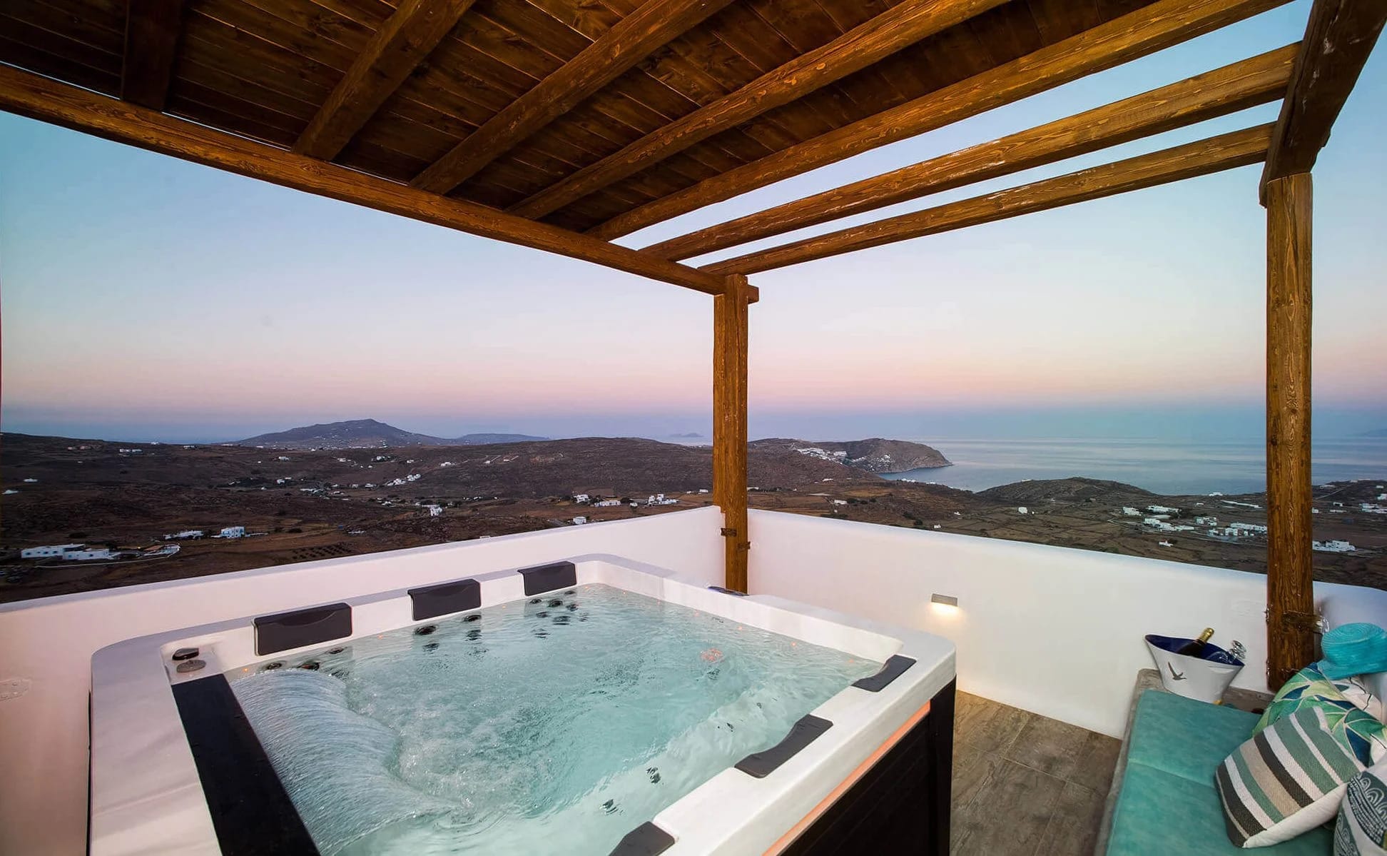 a pool with a view of a city and mountains in the background