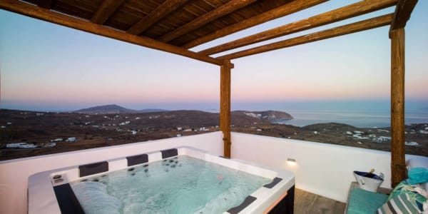 a pool with a view of a city and mountains in the background