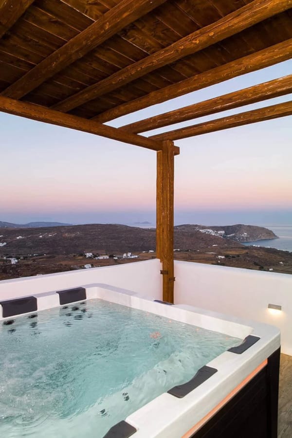 a pool with a view of a city and mountains in the background