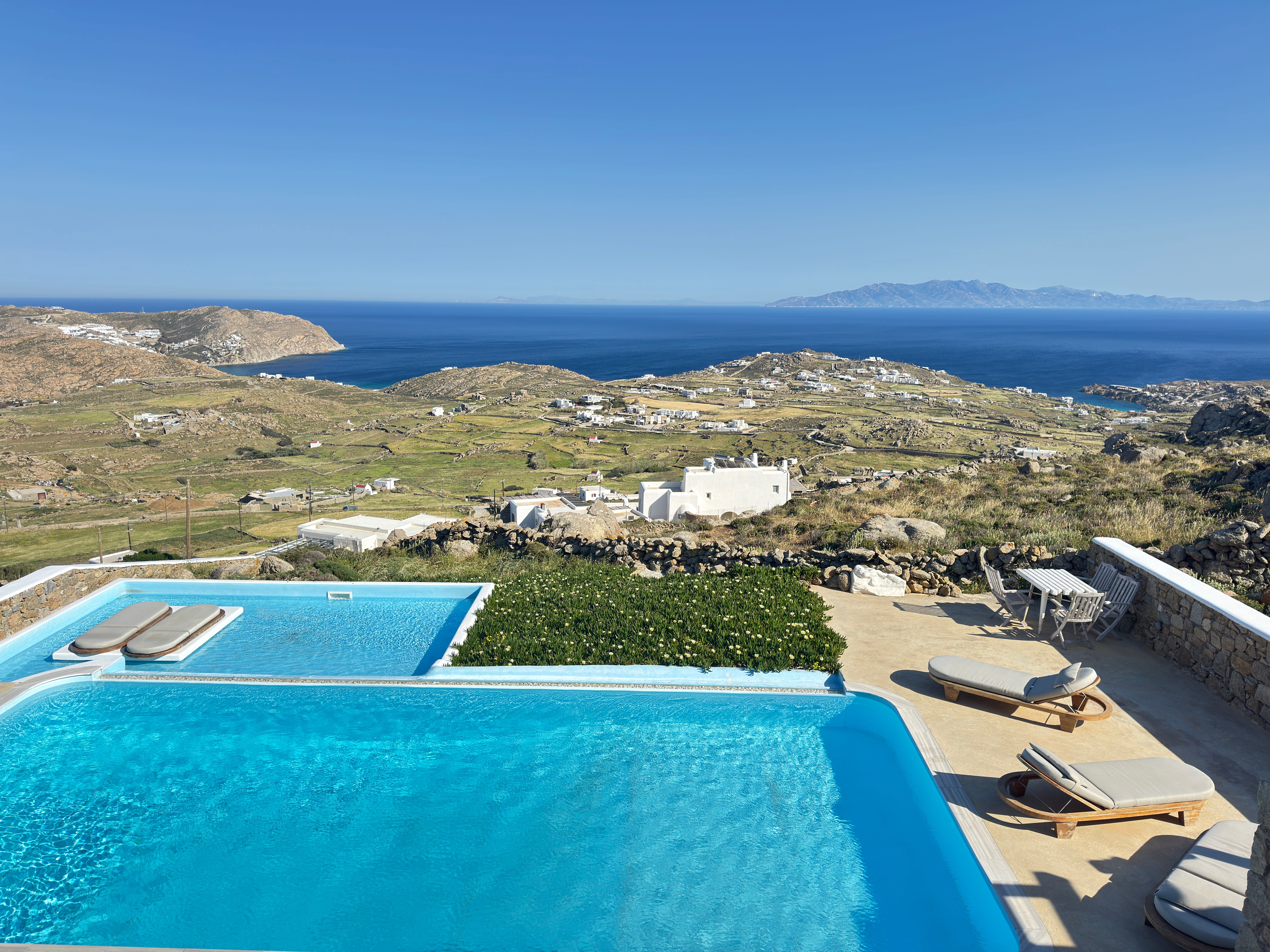 a pool with a view of a town and a beach