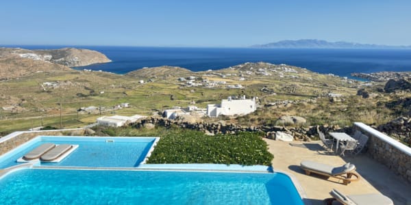 a pool with a view of a town and a beach