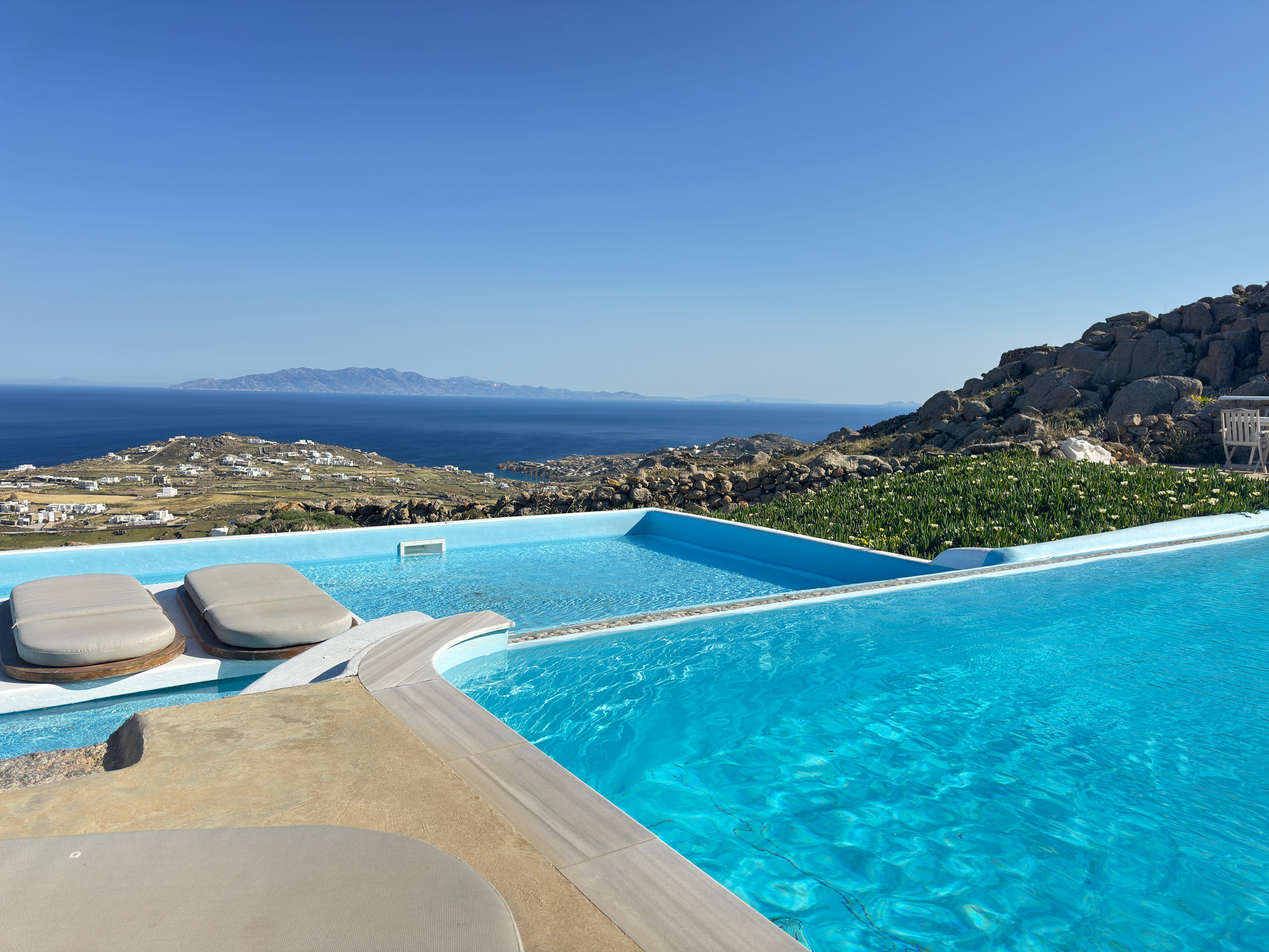 a pool with a beach and rocks