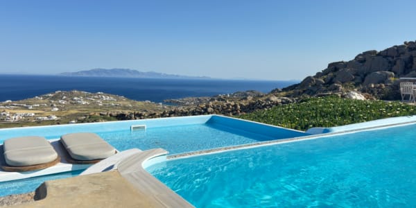 a pool with a beach and rocks