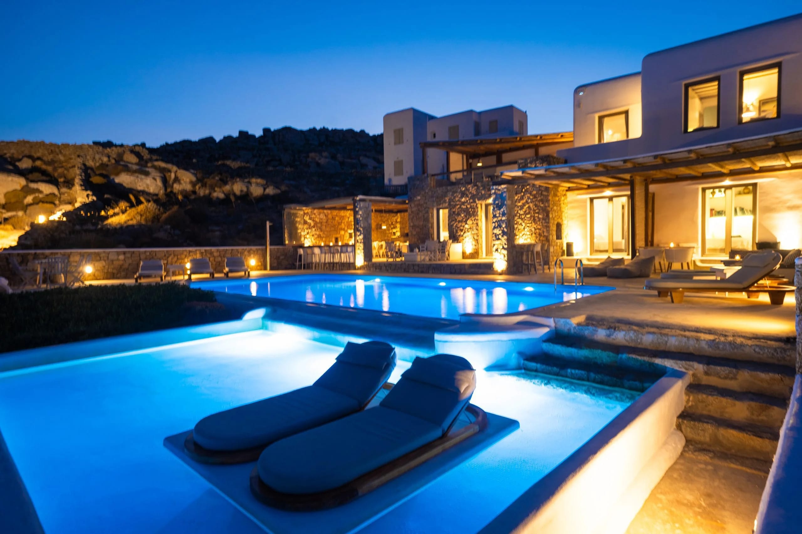 a pool with lounge chairs by it