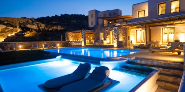 a pool with lounge chairs by it