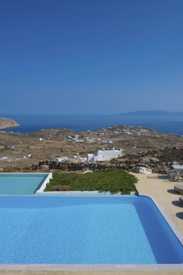 a pool on a hill overlooking a city