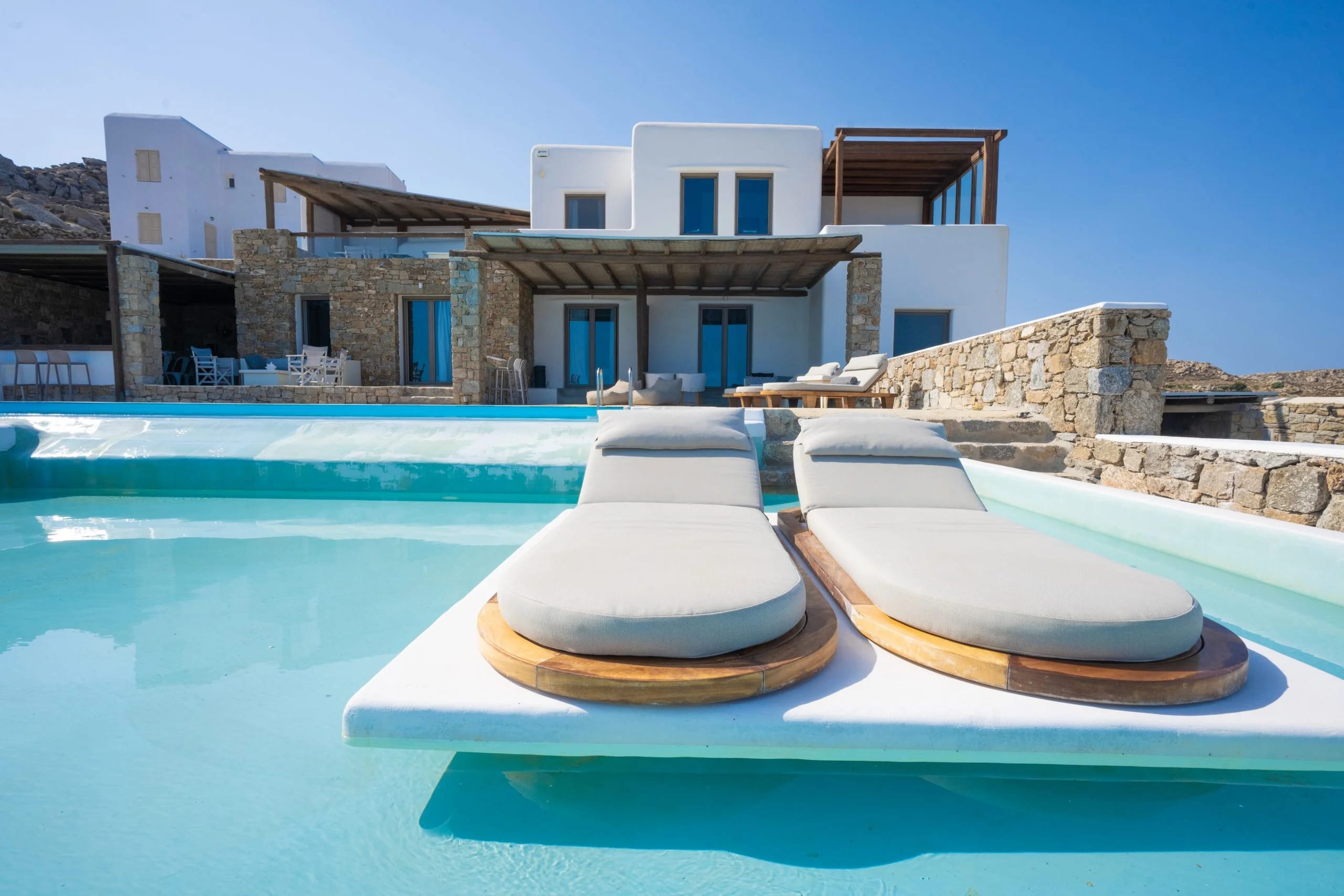 a pool with a house in the background