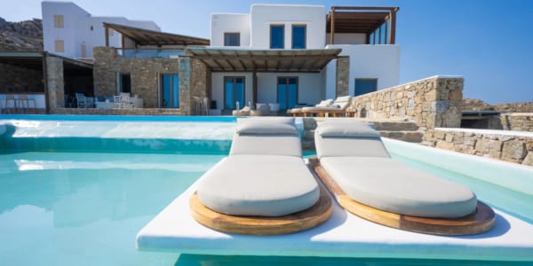 a pool with a house in the background