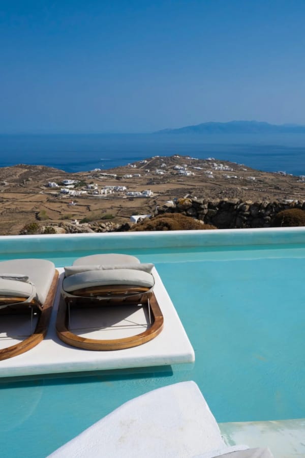 a pool with a beach in the background