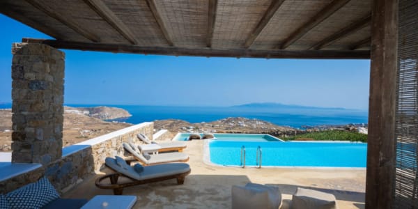 a pool and chairs on a beach