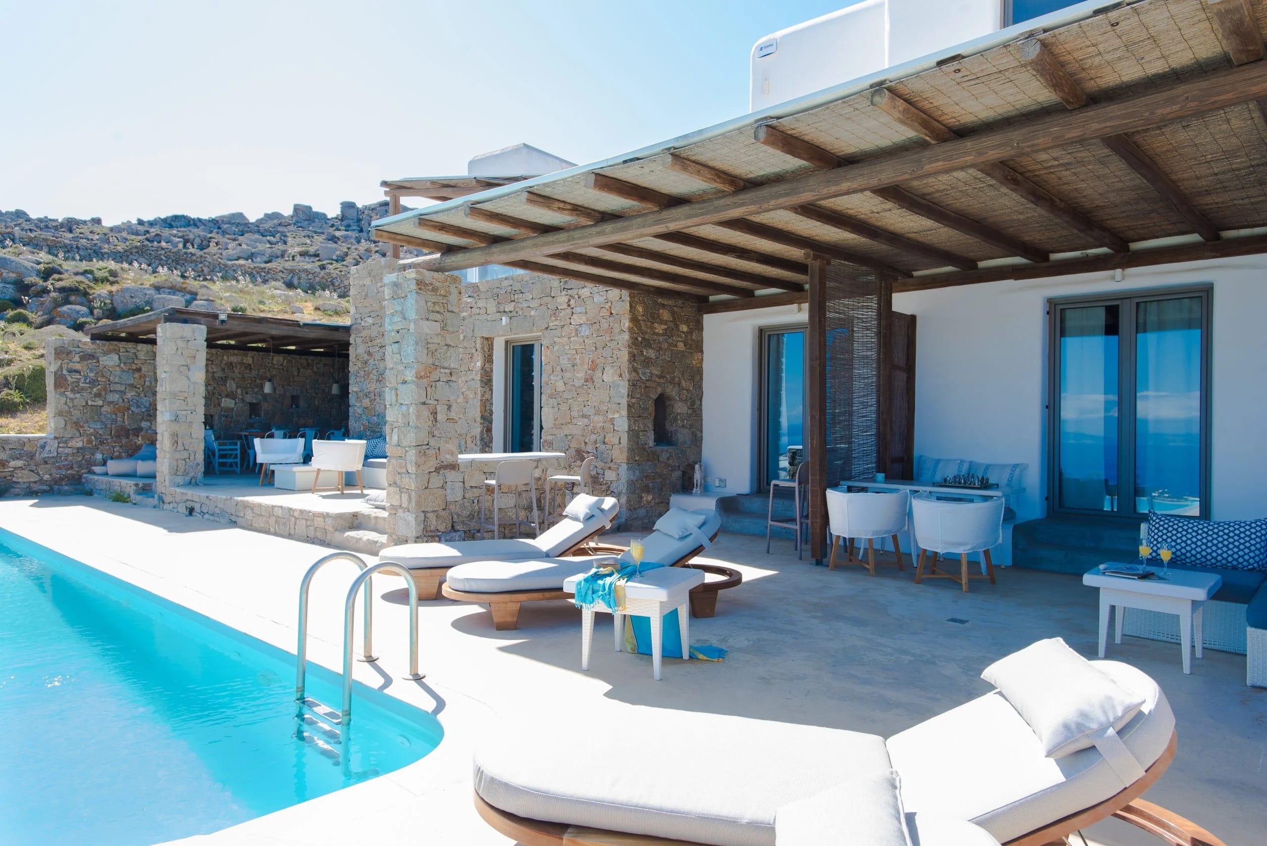 a pool with a deck and chairs