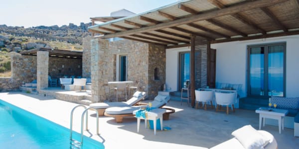 a pool with a deck and chairs