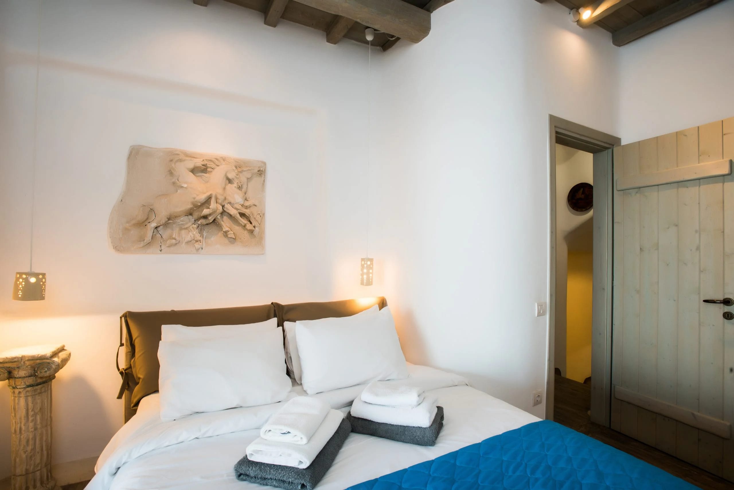 a bed with a blue blanket