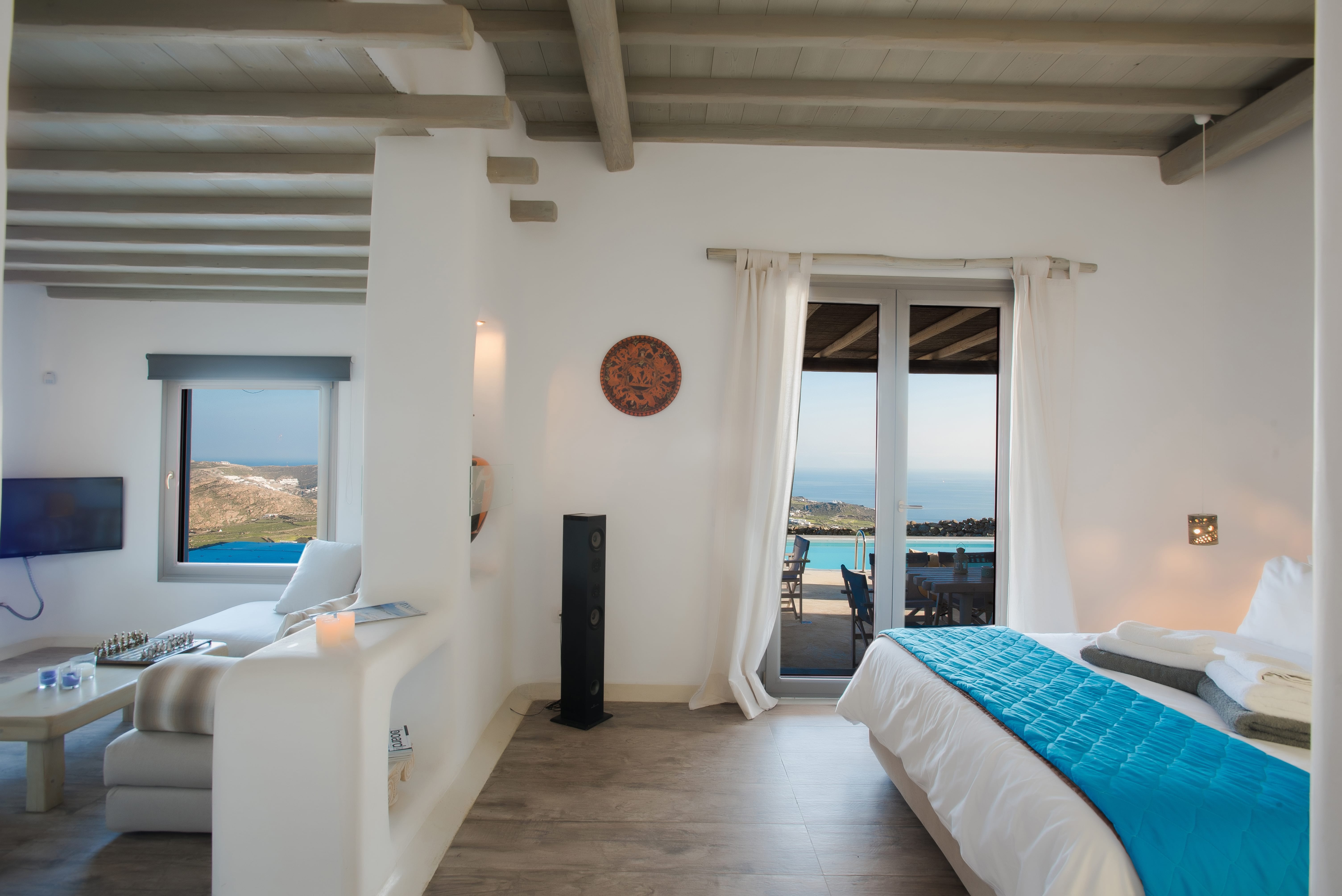 a bedroom with a bed and a television