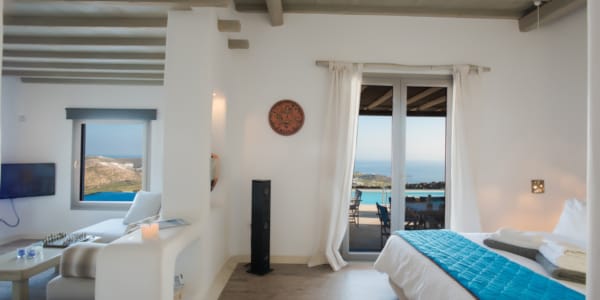 a bedroom with a bed and a television