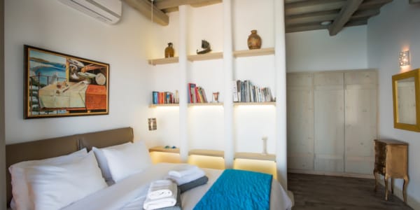 a bedroom with a bed and books