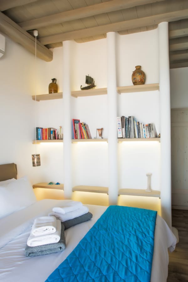 a bedroom with a bed and books