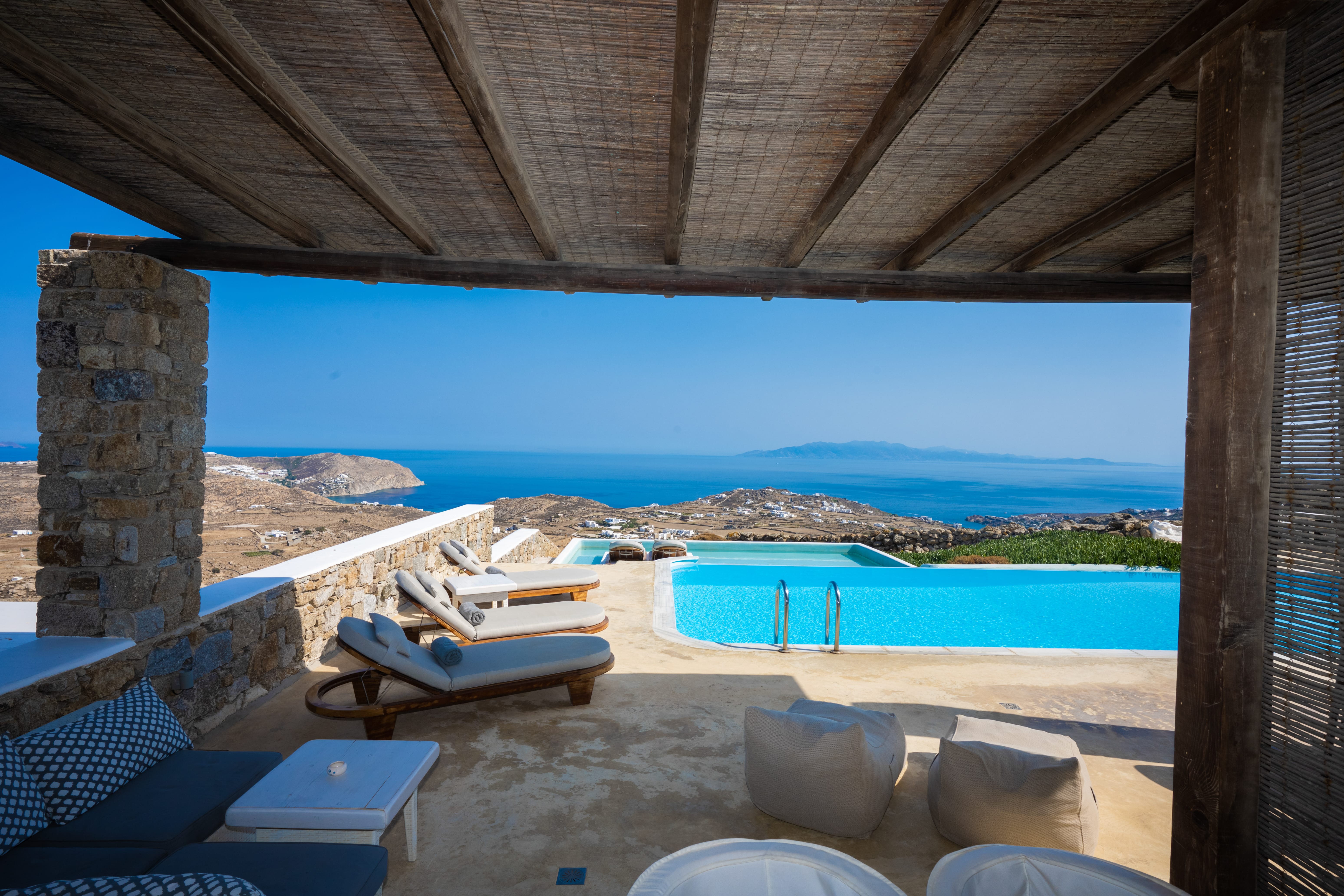 a pool and chairs on a beach
