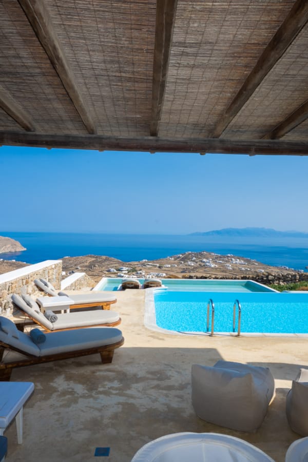 a pool and chairs on a beach