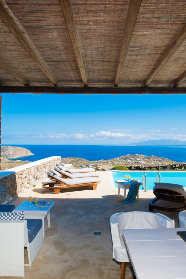 a deck with chairs and a pool