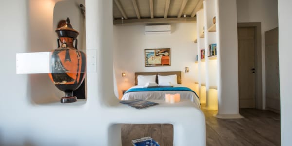 a bedroom with a bed and a lamp