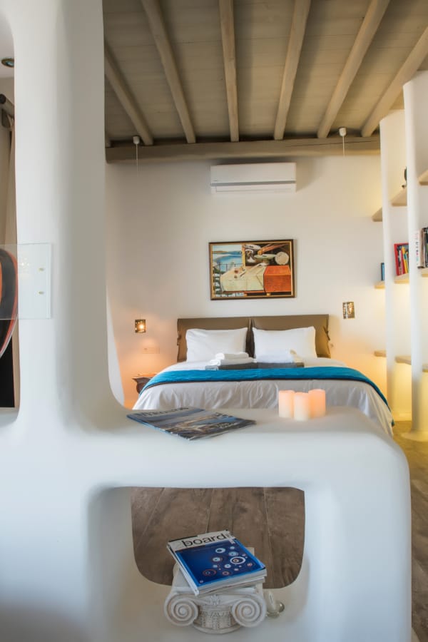 a bedroom with a bed and a lamp