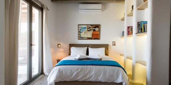 a bedroom with a bed and a bookcase