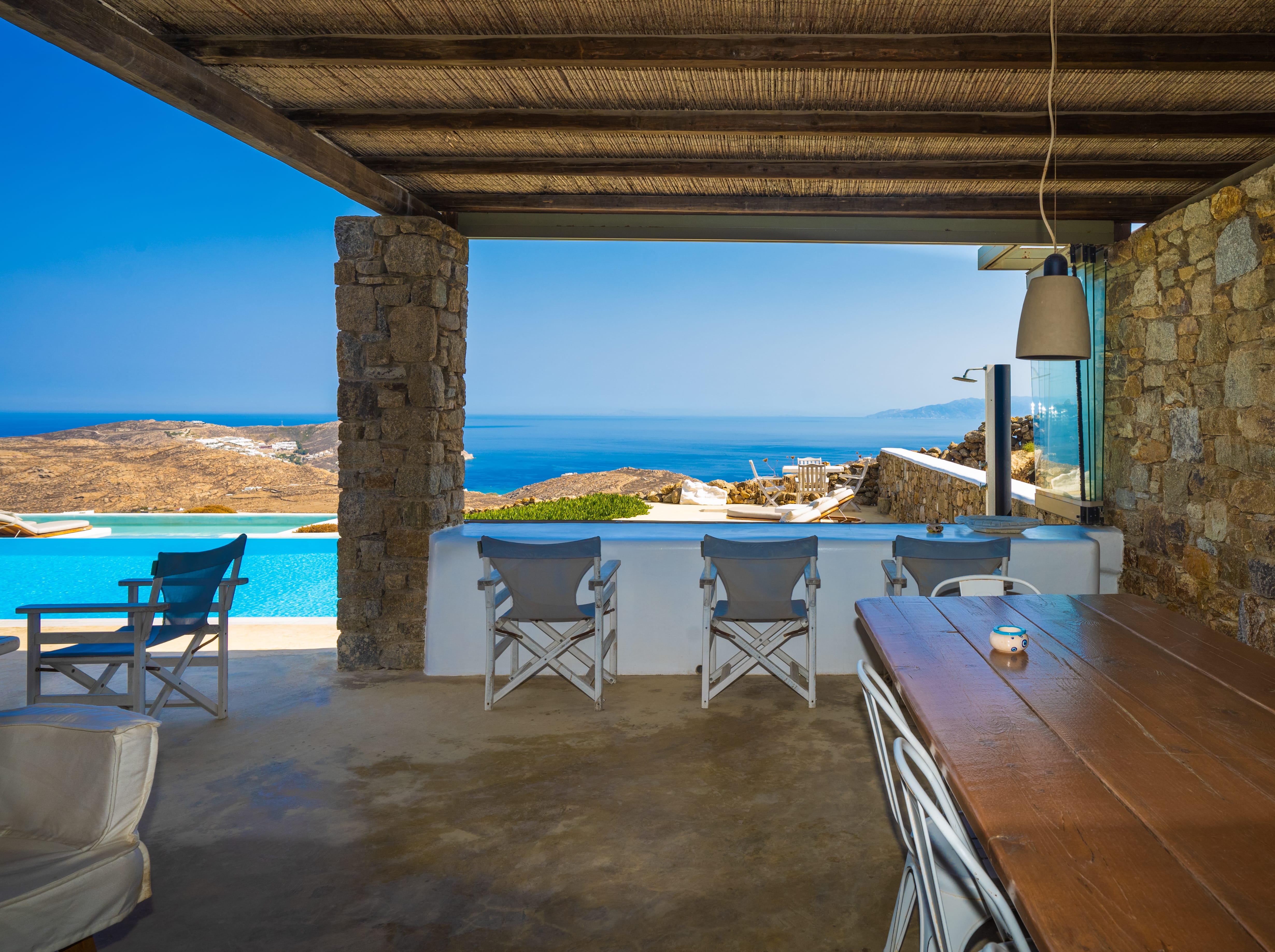 a table and chairs next to a pool