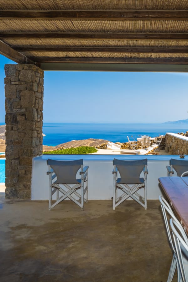 a table and chairs next to a pool
