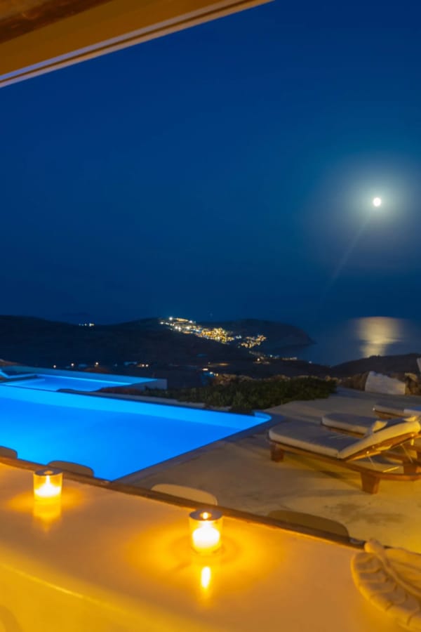 a pool with a view of the ocean and a city