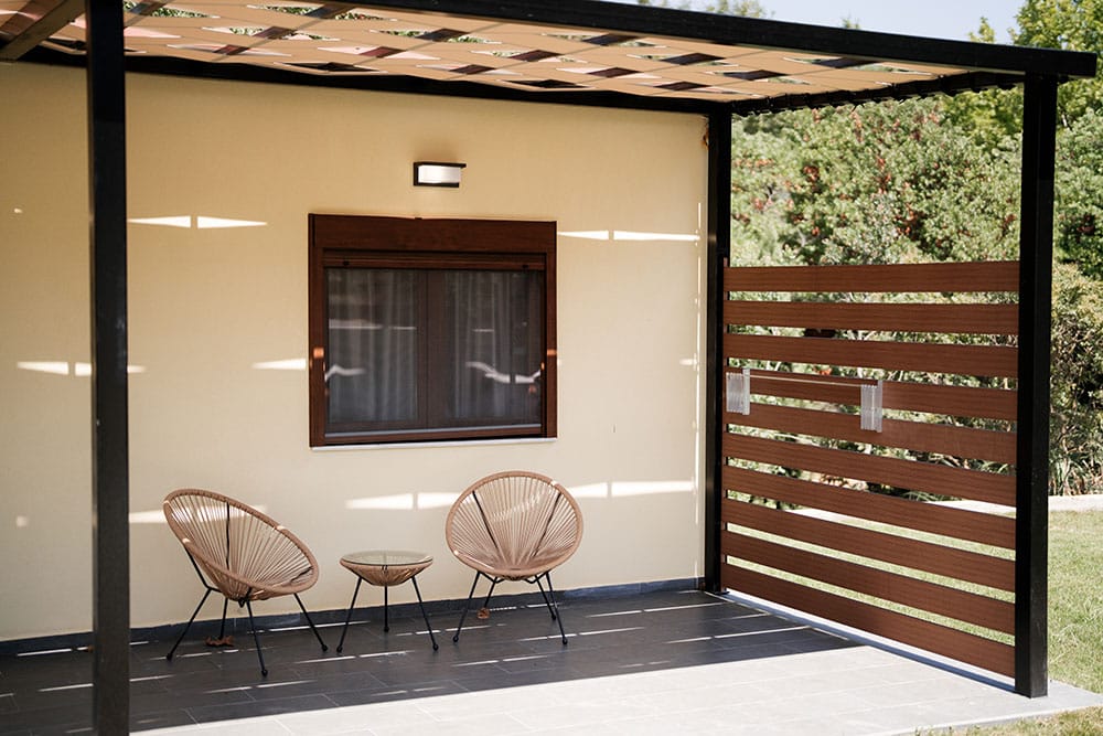 a patio with chairs and a table