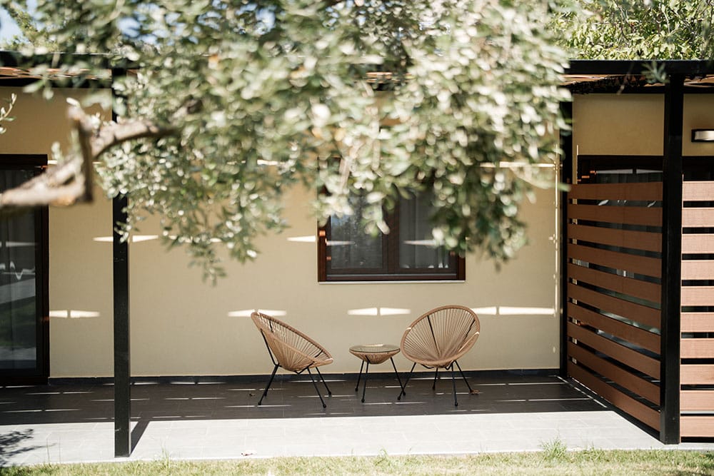 a couple of chairs and a table outside a building