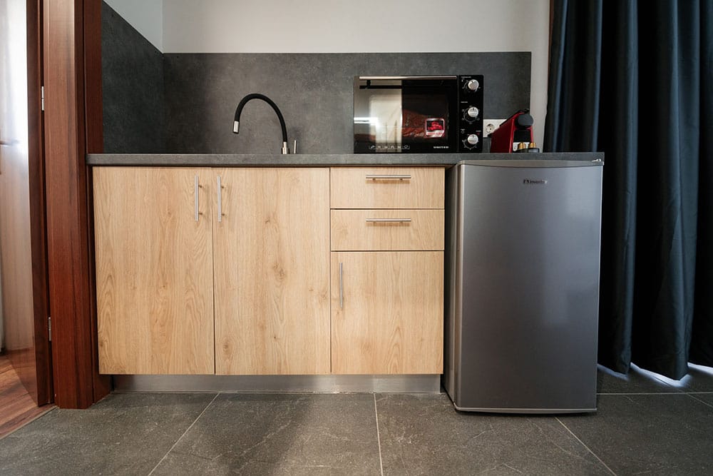a kitchen with a stainless steel refrigerator