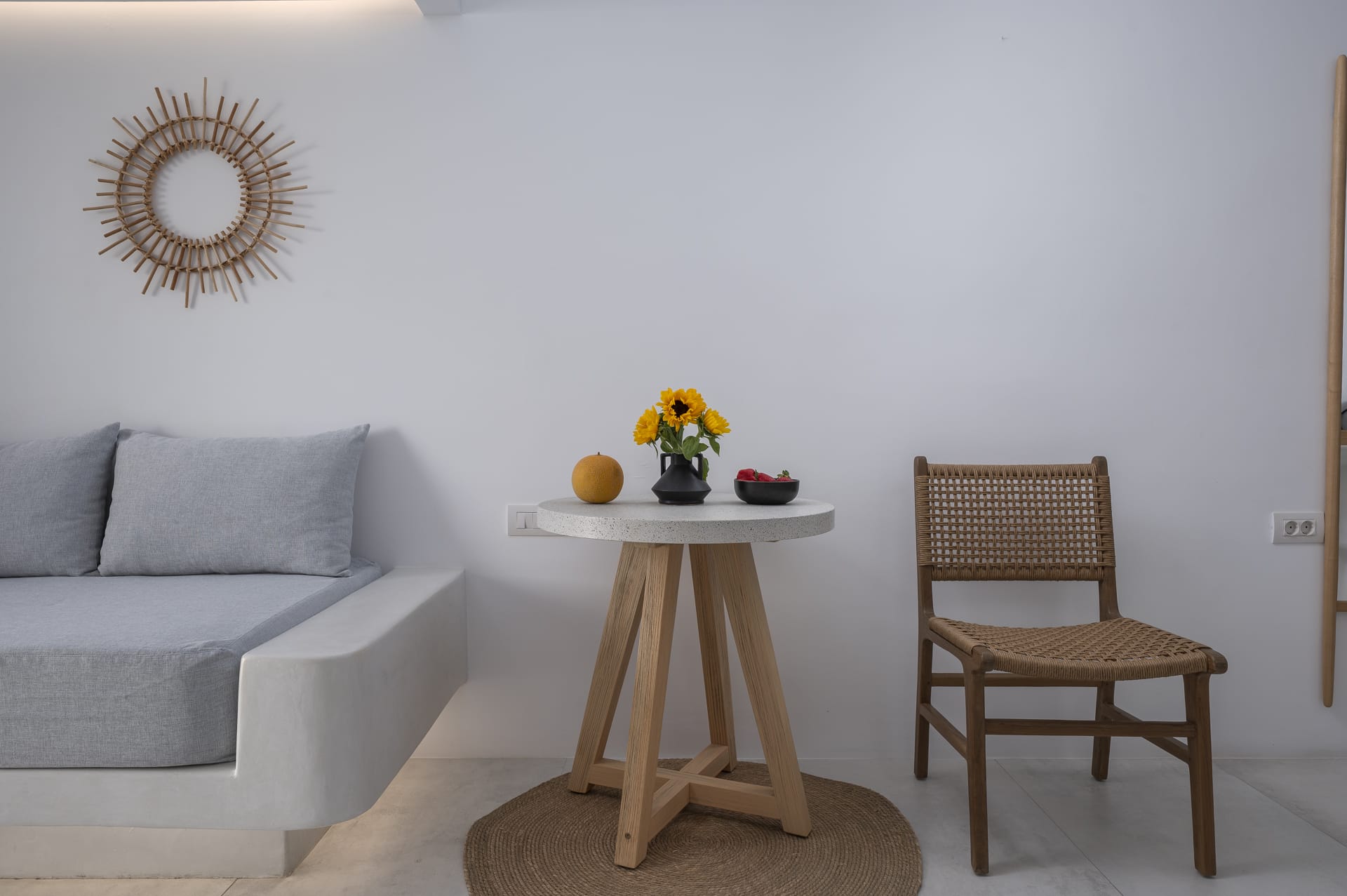 a table with a chair and a vase of flowers on it