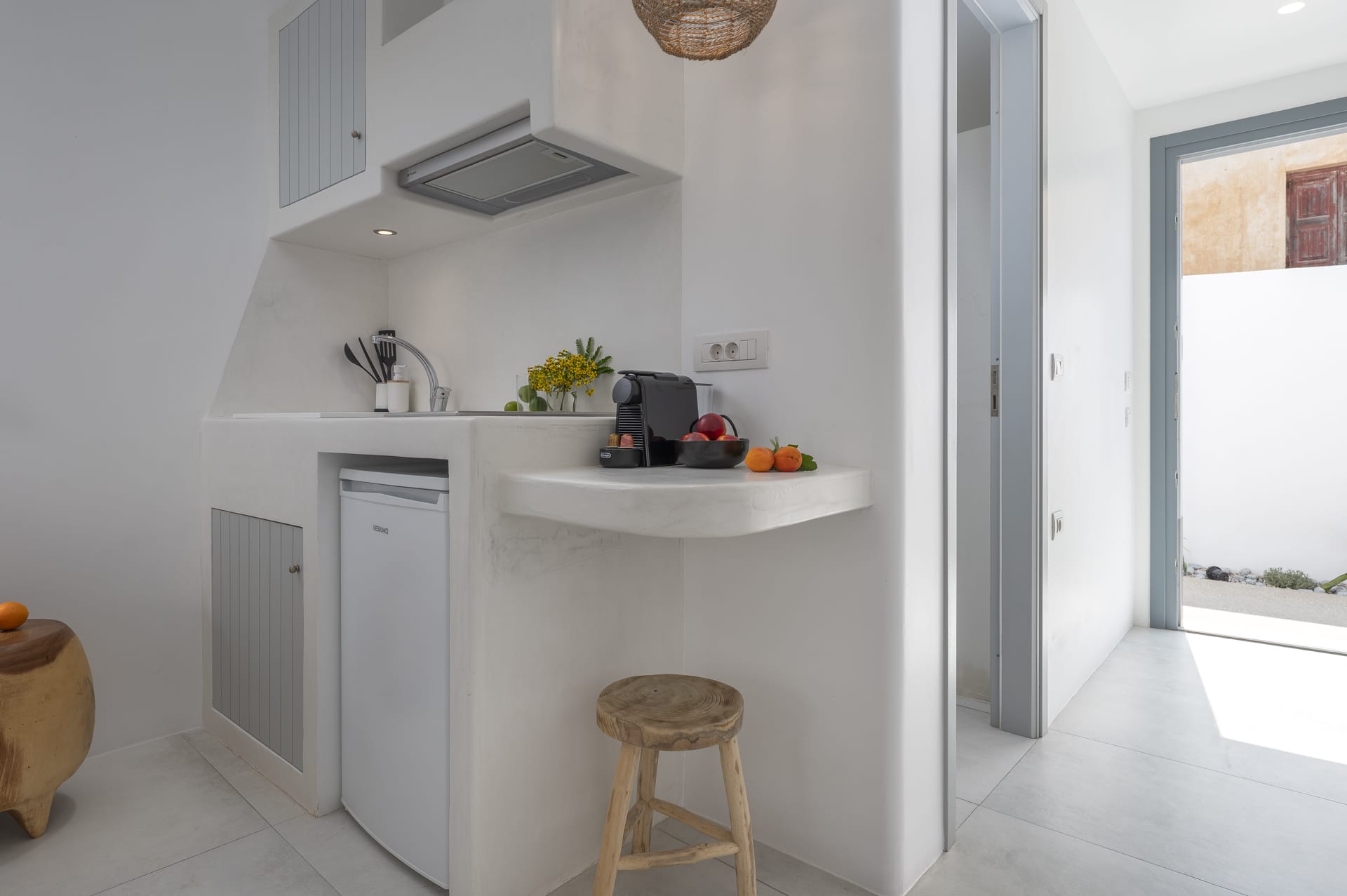 a white kitchen with a stool