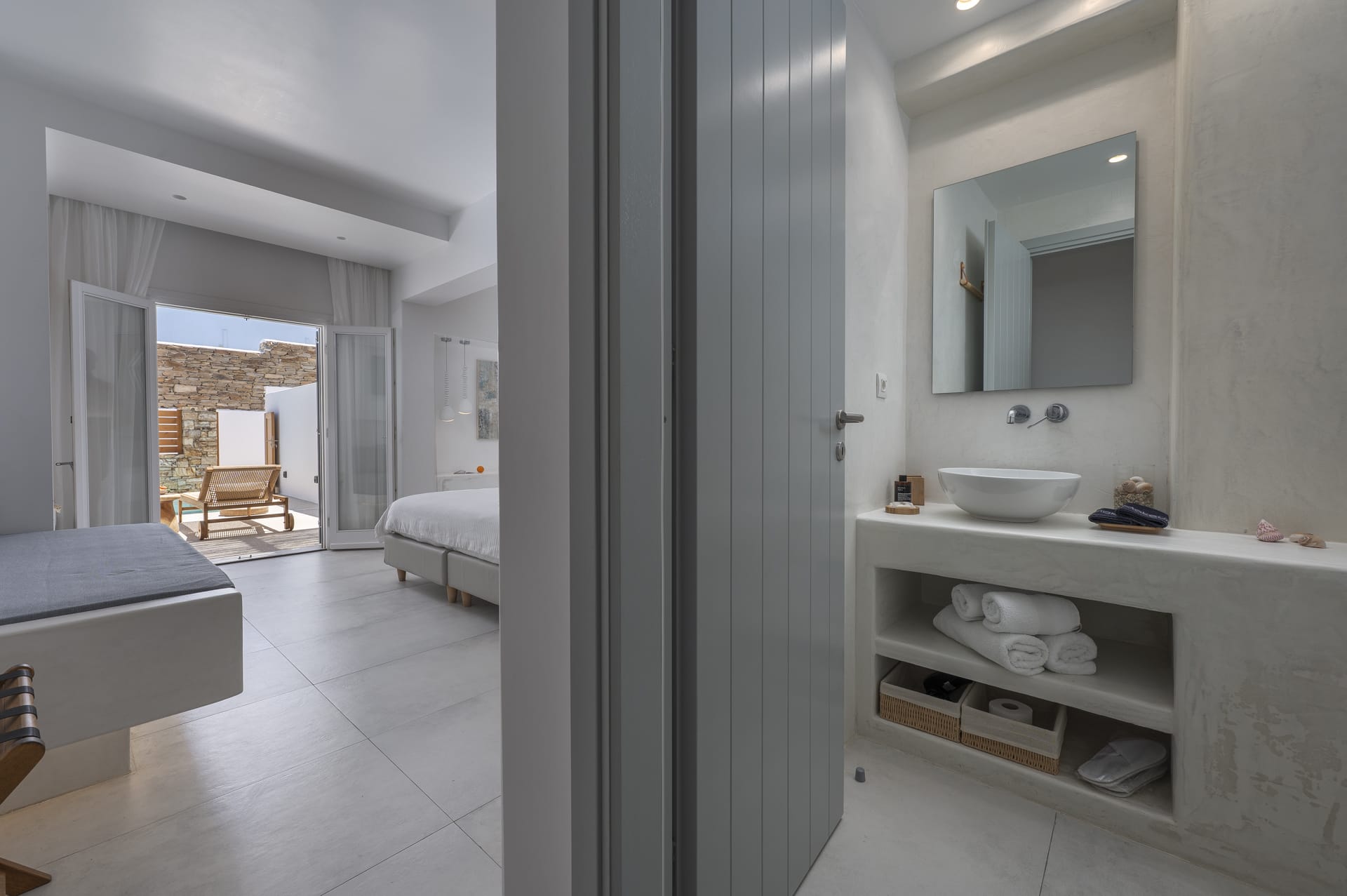 a bathroom with a sink and a bed