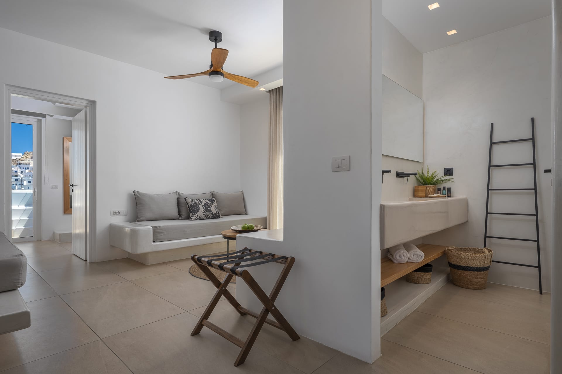 a living room with a white couch and a white wall