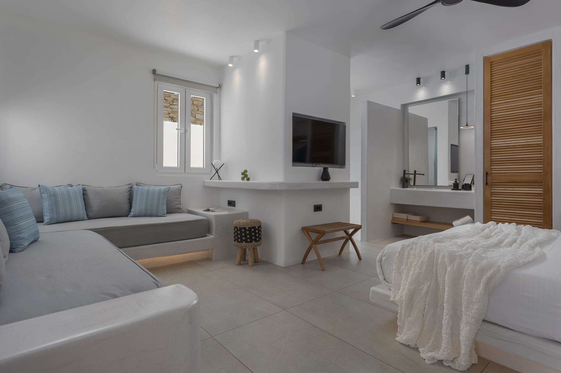 a room with a bed and a tv