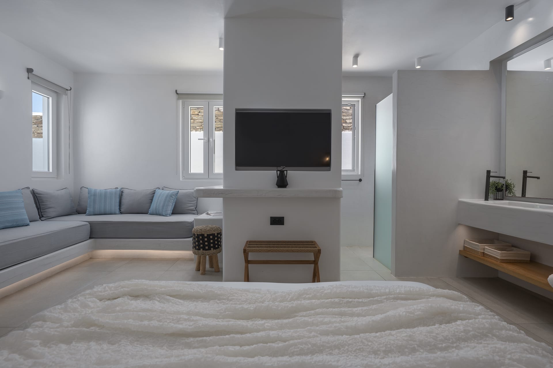 a room with a tv and couches