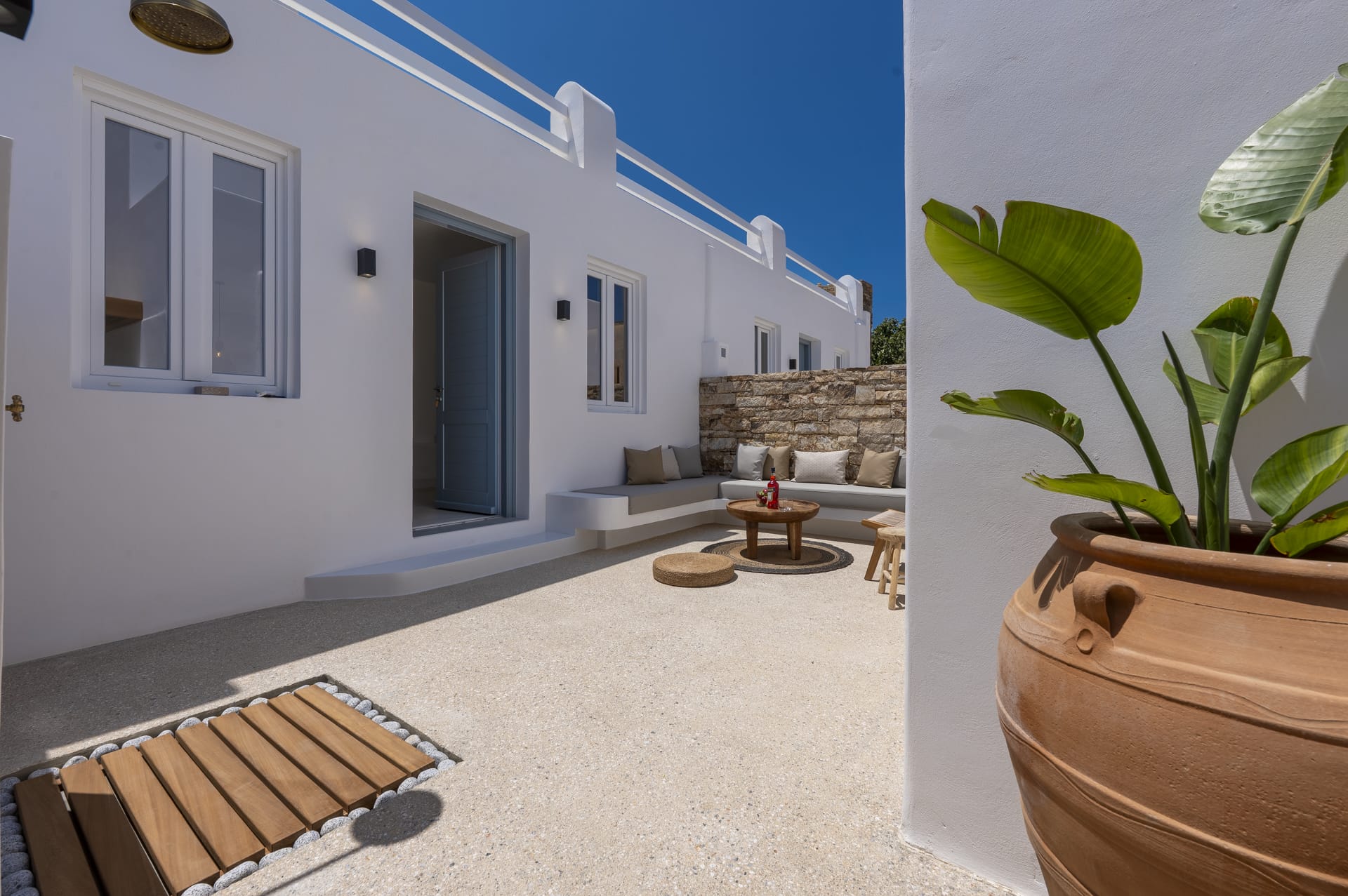 a house with a patio and a table and plants